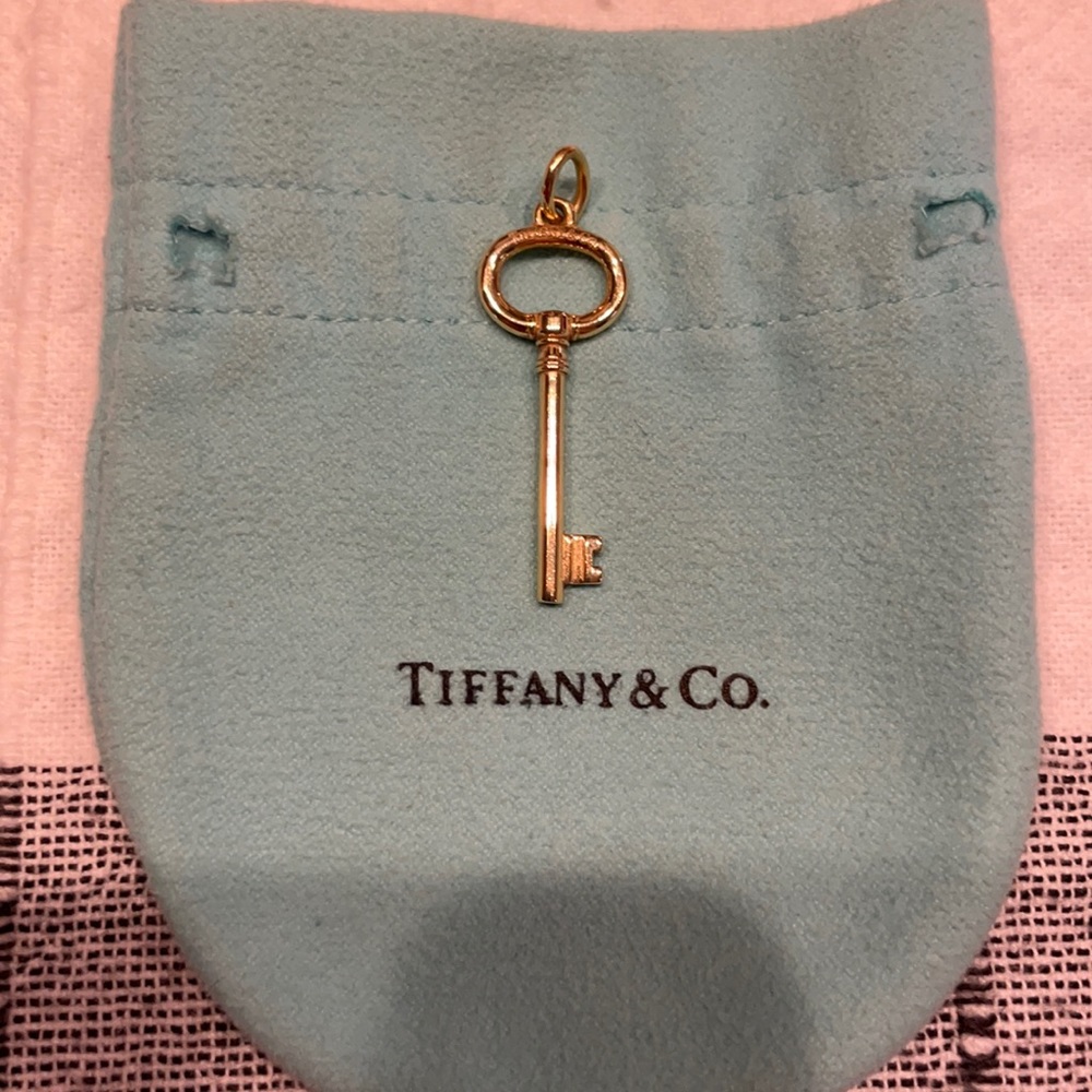 Authentic Tiffany & Co. 18K yellow gold key charm.
